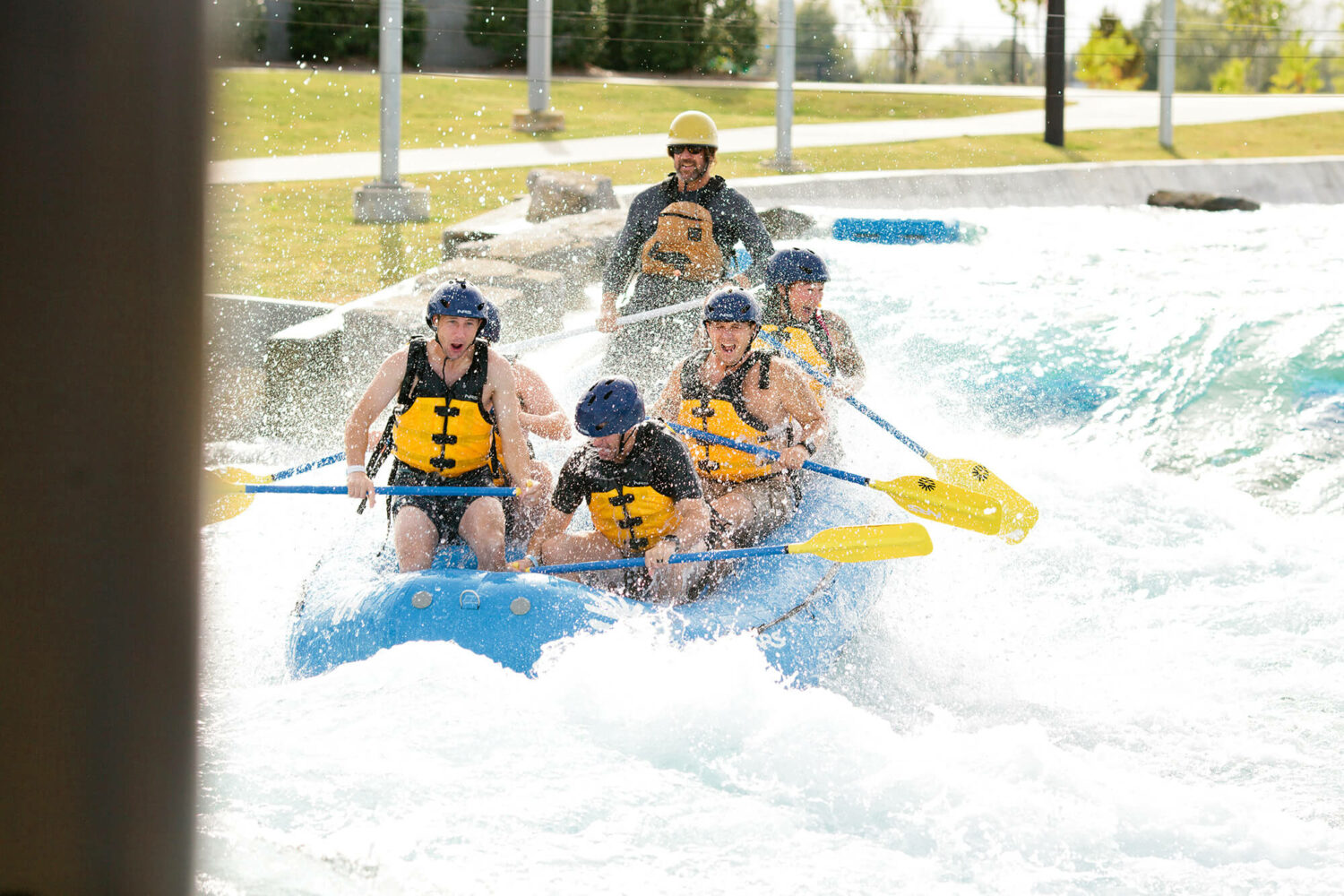 Group of guys whitewater rafting on the most advanced man-made whitewater facility, Montgomery Whitewater Park in Montgomery, Alabama.
